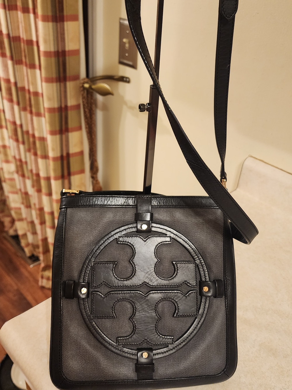 Tory Burch Holly crossbody bag featuring a black and gray design with the Logo